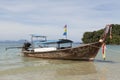 Beautiful beach with sea views and a traditional Thai fishing boat.Beautiful beach with tropical trees with a wave of the sea and