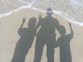 Beautiful beach, shadow of 3 people on the sand Royalty Free Stock Photo