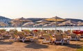 Beautiful beach on the shores of the calm blue bay of the Aegean Sea in the early morning. Beach vacation and holiday destination Royalty Free Stock Photo