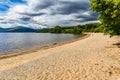 Beautiful beach on the shores of a large fresh water lake surrounded by mountains (Loch Lomond, Scotland