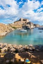 Beautiful beach in St. PaulÃÂ´s bay, Lindos acropolis in background (Rhodes, Greece)