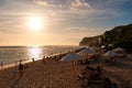 A beautiful beach with vacationers at sunset. The popular Melasti beach in Bali