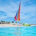 The beautiful beach of Varadero in Cuba with a colorful sailboat