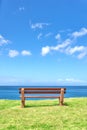 Beautiful beach view from a bench with copy space on a summer day with a blue sky background. Peaceful and calm seascape Royalty Free Stock Photo