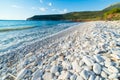 Beautiful beach and water bay in the greek spectacular coast line. Turquoise blue transparent water, unique white pebbles, Greece