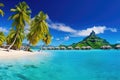 Beautiful beach with water bungalows and palm trees at Maldives, Luxury overwater villas with coconut palm trees, blue lagoon,