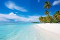 Beautiful beach with white sand, turquoise ocean, blue sky with clouds and palm tree over the water on a Sunny day. Maldives Royalty Free Stock Photo