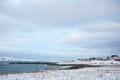 The beautiful beach in winter with snow and clouds Royalty Free Stock Photo