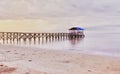 Beautiful beach with wooden boardwalk structure visible from a distance Royalty Free Stock Photo