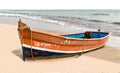 Beautiful beached Canoe, painted colorful in traditional Asian colors, this is powered by generator and used by local fishermen Royalty Free Stock Photo