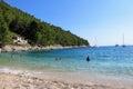 The beautiful beaches of Pupnatska Luka, on Korcula Island, Croatia. Locals and tourists are swimming and sunbathing