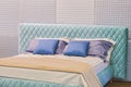 A beautiful bed unshaded with bed linens for advertising mattresses and pillows Royalty Free Stock Photo