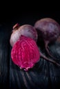 Beautiful beetle on a black background. Red beet in a dark key on a black table Royalty Free Stock Photo