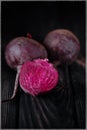 Beautiful beetle on a black background. Red beet in a dark key on a black table Royalty Free Stock Photo