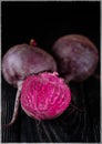 Beautiful beetle on a black background. Red beet in a dark key on a black table Royalty Free Stock Photo