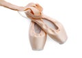 Beautiful beige ballet shoes with cute ribbons on white, top view
