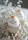 Beautiful beige colors morning table Two smiling eggs decoration with lace tablecloth and chamomile flowers. Breakfast eggs - Royalty Free Stock Photo