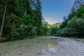 Beautiful Belca river, small clean water stream in the narrow valley of belca river, Slovenia. Grass on the riverbank, slow Royalty Free Stock Photo