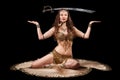 Beautiful belly dancer balancing sword Royalty Free Stock Photo