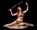 Beautiful belly dancer holding sword up Royalty Free Stock Photo