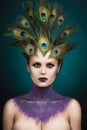 Beautiful big breast girl wearing peacock feathers in her hair a Royalty Free Stock Photo