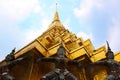 A beautiful big golden pagoda that have Thai giants protecting the base of the pagoda