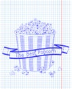 Beautiful big striped carton box full of delicious & fresh popcorn.Reel of film with inscription Royalty Free Stock Photo