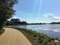 A beautiful bike and walking path along the ottawa river on a sunny summer day with blue sky.  The Supreme Court of Canada is back Royalty Free Stock Photo