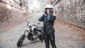 Beautiful biker woman outdoor with motorcycle.