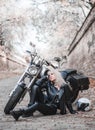 Beautiful biker woman outdoor with motorcycle.