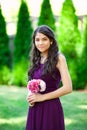 Beautiful biracial bridesmaid in purple dress, smiling