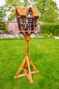 Beautiful bird feeder house stand in english garden Royalty Free Stock Photo