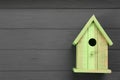 Beautiful bird house on grey wooden table, top view. Space for text Royalty Free Stock Photo