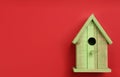 Beautiful bird house on red background, top view. Space for text Royalty Free Stock Photo