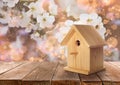 Beautiful bird house on wooden table outdoors, space for text Royalty Free Stock Photo
