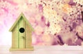 Beautiful bird house on wooden table outdoors, space for text Royalty Free Stock Photo