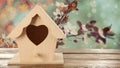 Beautiful bird house on wooden table outdoors, space for text Royalty Free Stock Photo