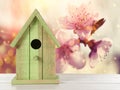 Beautiful bird house on wooden table outdoors, space for text Royalty Free Stock Photo
