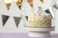 Beautiful birthday cake with burning candle on violet table. Space for text Royalty Free Stock Photo