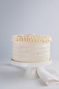 Beautiful Birthday Cake decorate with edible pearls on white neutral background.