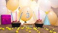 A beautiful birthday card for a girl with the number 3 in a cupcake against the background of balloons. Happy birthday to a three Royalty Free Stock Photo