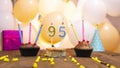 A beautiful birthday card for a woman with the number 95 in a cupcake against the background of balloons. Happy birthday