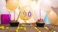 A beautiful birthday card for a woman with the number 90 in a cupcake against the background of balloons. Happy birthday ninety