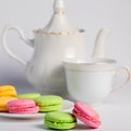 Beautiful biscuits of different colors for tea on a white background