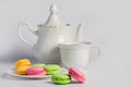 Beautiful biscuits of different colors for tea on a white background