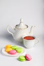Beautiful biscuits of different colors for tea on a white background