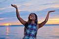 Beautiful black African American woman posing on the beach at sunset Royalty Free Stock Photo