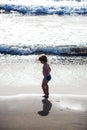 Beautiful black beach in Tenerife. Black sand in the Canary islands. Happy child touches water in the warm ocean. Summer