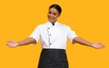 Beautiful black chef woman chef showing empty palms, spreading arms at camera