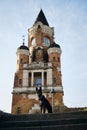 Beautiful black dog sits and poses near Gardos Tower -Millenium Tower- in Belgrade, Serbia. Old town Zemun district